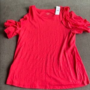 Bright pink peak a boo shoulder top.